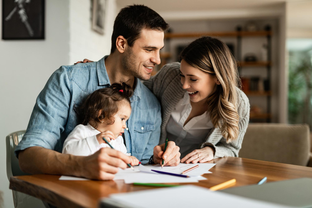 Young parents with baby reviewing term life insurance documents together at home